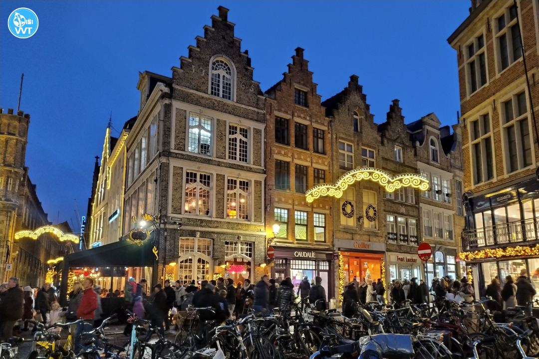 Photo of typical houses with Christmas decorations on the Market Square of Bruges